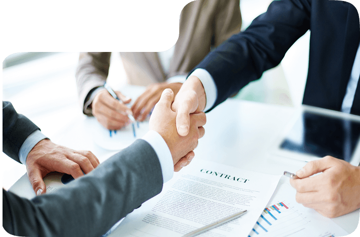 Business professionals shaking hands over a contract